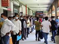 Migrant workers wait in a queue to receive a dose of the Moderna vaccine against the Covid-19 coronavirus in Dhaka, Bangladesh on July 27, 2...