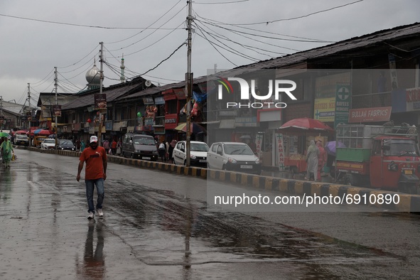 A man walks after Heavy rainfall started in Sopore, District Baramulla Jammu And Kashmir, India on 28 July 2021. 4 dead, 36 missing after cl...