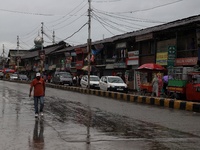 A man walks after Heavy rainfall started in Sopore, District Baramulla Jammu And Kashmir, India on 28 July 2021. 4 dead, 36 missing after cl...