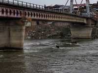Commuters walk over a brigde during Rainfall in Sopore, District Baramulla Jammu And Kashmir, India on 28 July 2021. 4 dead, 36 missing afte...
