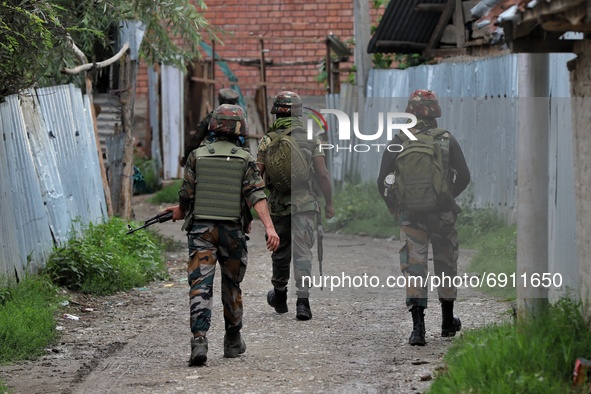 An Indian Army Soldier stands alert during a Cordon and Search Operation after suspected militants on Wednesday hurled a grenade towards pol...