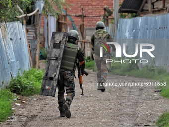 Indian Army Soldiers walk during a Cordon and Search Operation after suspected militants on Wednesday hurled a grenade towards police party...
