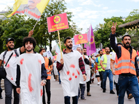 Kurdish demonstrators wear bloodstained clothing to remind the PKK martyrs who fought against Daesh in Paris, France, on July 28, 2021. Kurd...
