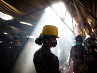 Police personnel inspects the site after extinguishing a fire in a local furniture company in Kathmandu, Nepal on  July 28, 2021.  (