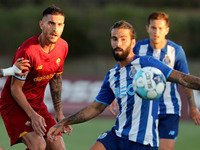 Lorenzo Pellegrini of AS Roma (L) vies with Sergio Oliveira of FC Porto (C ) during an international club friendly football match between AS...