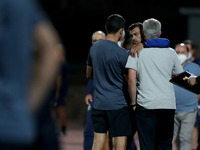 FC Porto's head coach Sergio Conceicao (C ) hugs AS Roma's head coach Jose Mourinho (R ) during an international club friendly football matc...