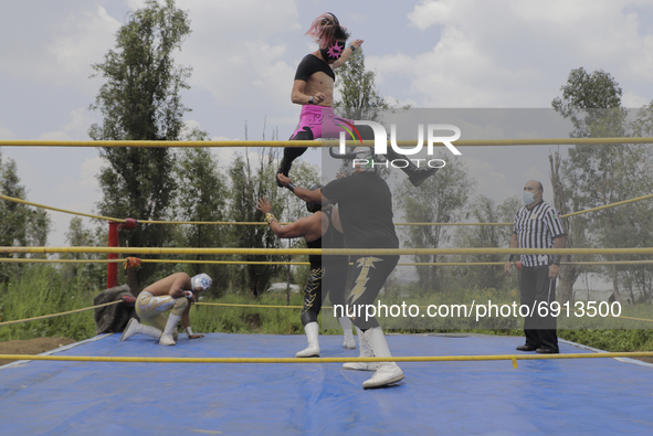 Sol, Ciclónico and Mr. Jerry, professional wrestlers, during a wrestling match where they went head to head with other gladiators in a ring...
