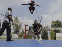Sol and Mr. Jerry, professional wrestlers, during a wrestling match where they went head to head with other gladiators in a ring at the Emba...