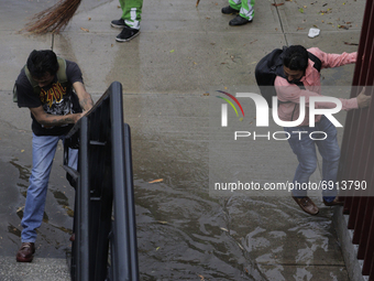 Passersby try to evade puddles after registering a heavy rain in Mexico City where there were several floods in the municipalities of Coyoac...
