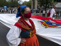 A woman in a typical Cantabrian costume parades with the flag of autonomy through the streets of Santander to commemorate the Day of Institu...