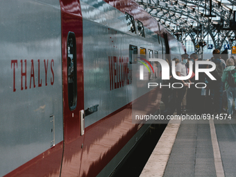 travellers step into a Thalys train  in the platform in Cologne central station, Germany on July 29, 2021 as germany plans restricter corona...