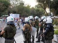 Riot police near the demonstration for protection of the public buildings. Hundreds of people, less than the big previous rally, are seen at...