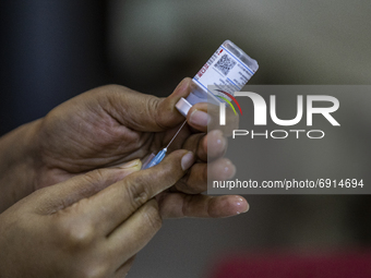 A health worker prepares a vaccine dose to inoculate a people with a dose of the Moderna vaccine against the Covid-19 coronavirus at the Hos...