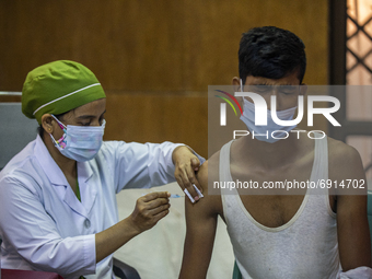 A health worker inoculates a man with a dose of the Moderna vaccine against the Covid-19 coronavirus at the Hospital in Dhaka, Bangladesh, o...