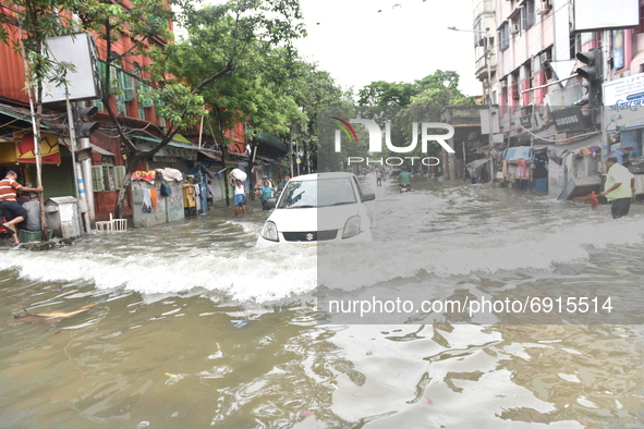 A taxi is seen waded through a waterlogged street in Kolkata, India, on July 30, 2021. 