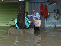 A man is seen buys flowers in the water logged street which disrupted daily life in Kolkata, India, on July 30, 2021. (
