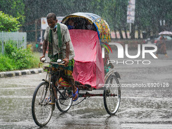 A man is pulling a rickshaw during the rainfall in Dhaka, Bangladesh on July 31, 2021. (