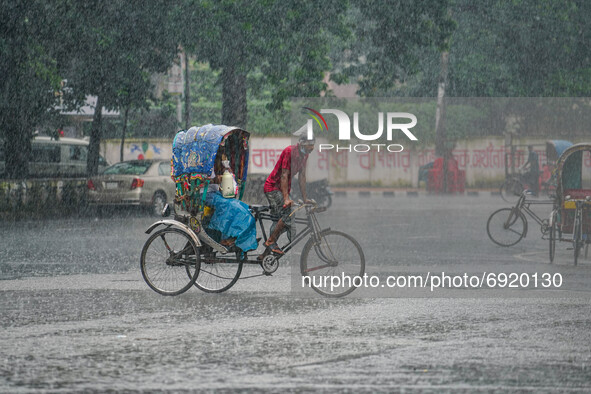 A man is pulling a rickshaw during the rainfall in Dhaka, Bangladesh on July 31, 2021. 