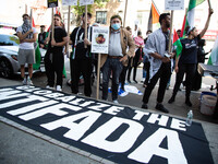 A sign reading ''Globalize The Intifada'' is seen on the ground as people demonstrate in support of Palestine in Brooklyn, New York, US, on...