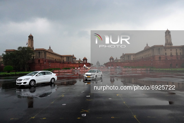 Vehicles move past the Raisina hills during a light spell of rain in New Delhi, India on August 2, 2021. 