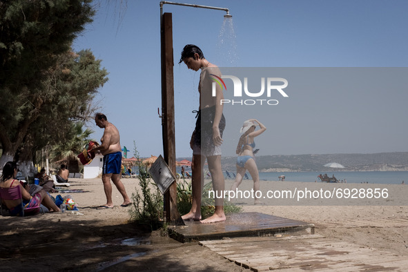 These days Chania reached 40 degrees celsius. Locals and tourists are enjoying the warm weather and take a swim at Kiani Akti beach near Cha...