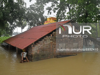 A man takes household items from his house which got submerg under the flooded water in Udaynarayanpur, Howrah district of West Bengal, Indi...