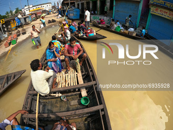 
Indian flood victims on a boat make their way through flood waters after collecting relief materials in the Ghatal area of Paschim Medinip...