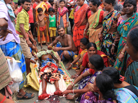 Reliative  gaders a local villeger dead body  in the flood hit city of Amta-2 in the Howrah district about 82 kms from Kolkata on August 7,...