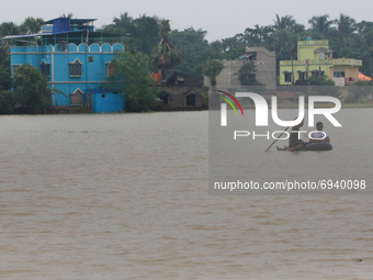  Flood-affected villagers wading through a flooded hamlet in the flood-affected  Amta-2 in the Howrah district about 82 kms from Kolkata, In...