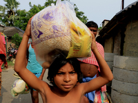 Indian flood-affected children collect food packets from flood waters after they were distributed by State Goverment in the flood hit city o...