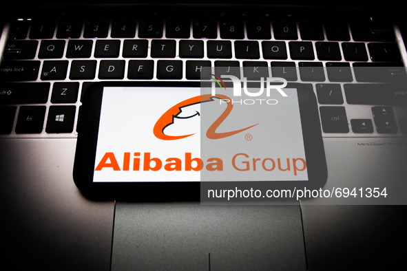 Alibaba Group logo displayed on a phone screen and a laptop keyboard are seen in this illustration photo taken in Krakow, Poland on August 7...