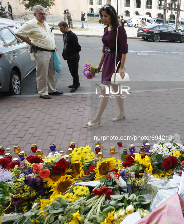 Ukrainians place flowers in commemoration of the victims of Malaysia Airlines MH17 plane accident in eastern Ukraine, in front of the Dutch...