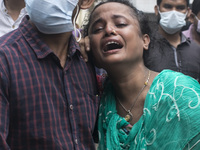  A woman weeps while  receive the remains of her loved one who died in the deadly fire that had engulfed a Narayanganj factory last month. A...