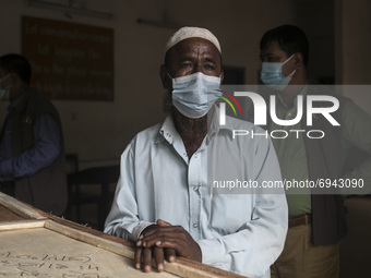 A man weeps while  holds the coffin with the remains of his relative who died in the deadly fire that had engulfed a Narayanganj factory la...