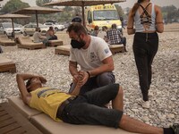 A ferry is hosting people who can't evacuate in the Pefki village, in Evia Island, Greece, on August 8, 2021. Some people are staying in the...