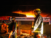 Fire volunteers responded on a 3rd alarm fire hits in public market of Teresa in Rizal, Philippines on night of August 11, 2021. Despite of...