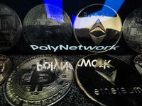 Poly Network logo displayed on a phone screen and representation of cryptocurrencies are seen in this illustration photo taken in Sulkowice,...