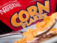 Nestle Corn Flakes logo on the packaging and a breakfast cereal are seen in this illustration photo taken in Sulkowice, Poland on August 12,...
