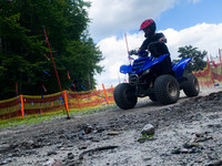 A kid rides a small quad bike on a track in Kocierz, Poland on August 12, 2021. (
