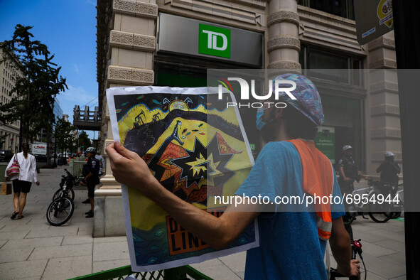 Demonstrators with the organization Climate First! protest outside of several branches of major banks on August 13, 2021 in Washington, D.C....
