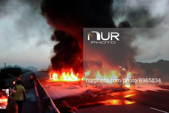 A fire breaks out after a collision between two trucks on a National Highway near Ajmer, Rajasthan, India on 17 August 2021. Four people bur...
