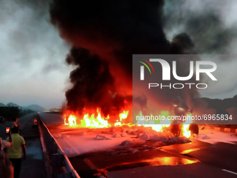 A fire breaks out after a collision between two trucks on a National Highway near Ajmer, Rajasthan, India on 17 August 2021. Four people bur...