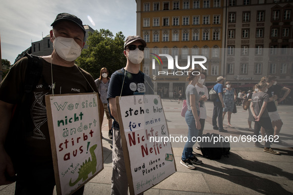 Environmentalists protest in Munich, Germany  on August 13, 2021 to raise awareness of climate change . On the occasion of the various event...