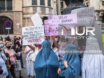 Protesters are seen with burqas and banners that say, I do not defend any religion because they are all against women, neither the veil nor...