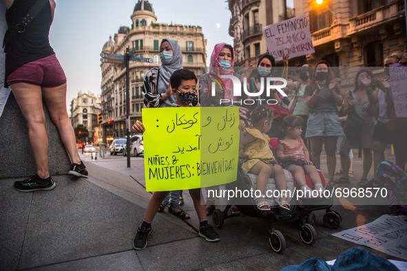 Child is seen with a banner that reads, children and women: welcome.Around a hundred women have participated in a feminist demonstration in...