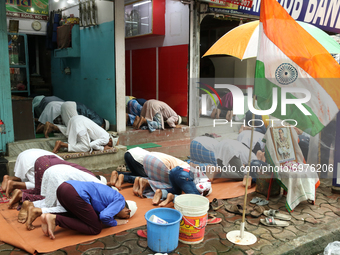 Muslim men offer Friday prayers on the Street Side Footpath and Ride side Indian National Flagh  in Kolkata on August 20,2021. (
