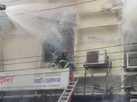 Firefighters try to extinguish a fire at a building at Bonani area in Dhaka, Bangladesh, on August 21, 2021. According to fire services, the...