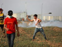 Palestinian protesters during a demonstration by the border fence with Israel, east of Gaza City, denouncing the Israeli siege of the Palest...