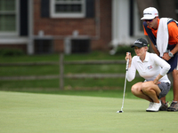 Sarah Jane Smith lines up her putt flanked by her husband and caddy, Duane Smith, at the 14th green after finishing the hole during the seco...