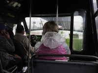 A woman aboard a bus carrying a windbreaker jacket after rains and strong gusts of wind in Mexico City due to Hurricane Grace, which is adva...